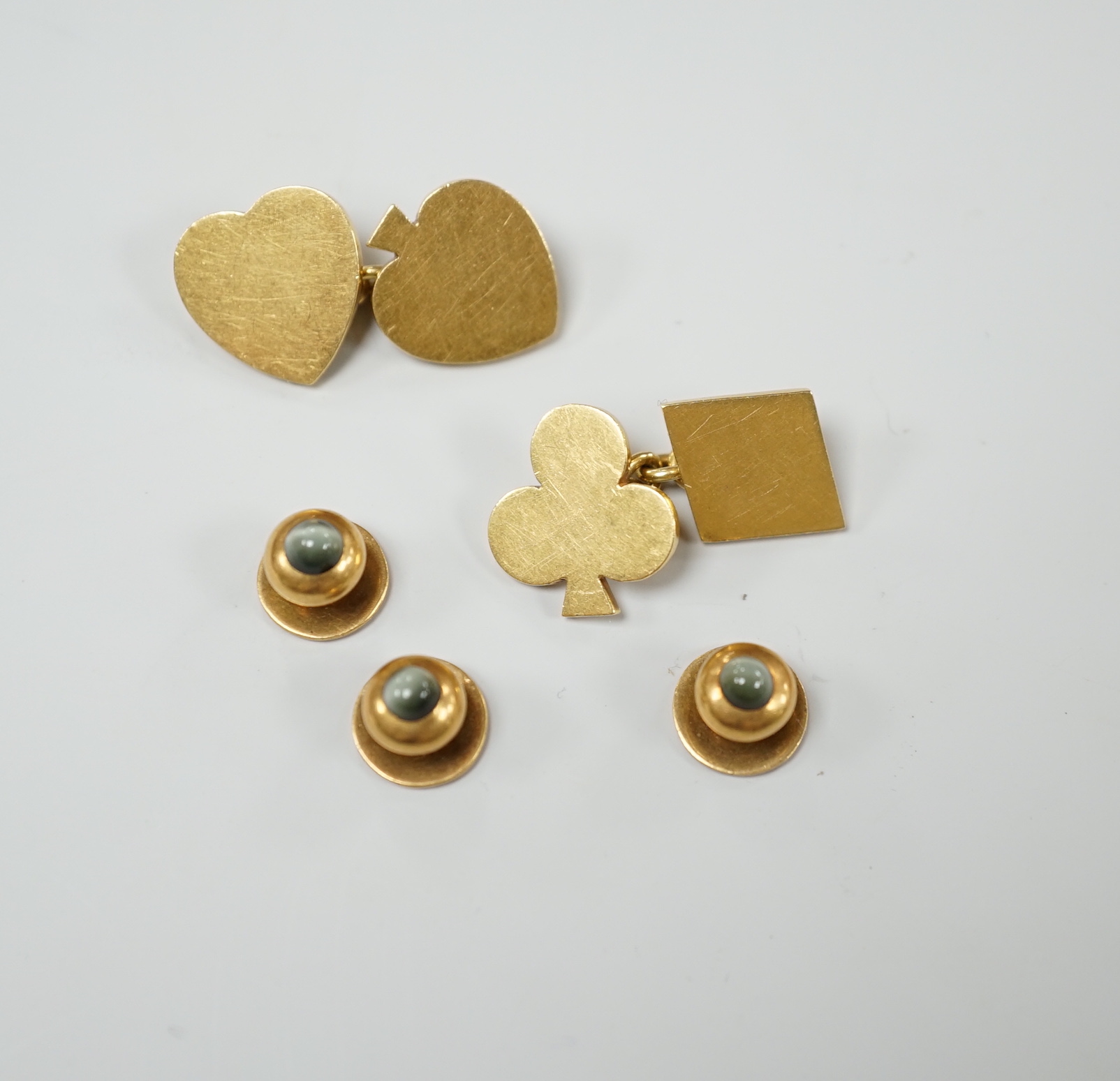 A pair of early 1970's 18ct gold novelty playing card suite cufflinks, 16 grams, together with three yellow metal and cat's eye chrysoberyl set dress studs.
